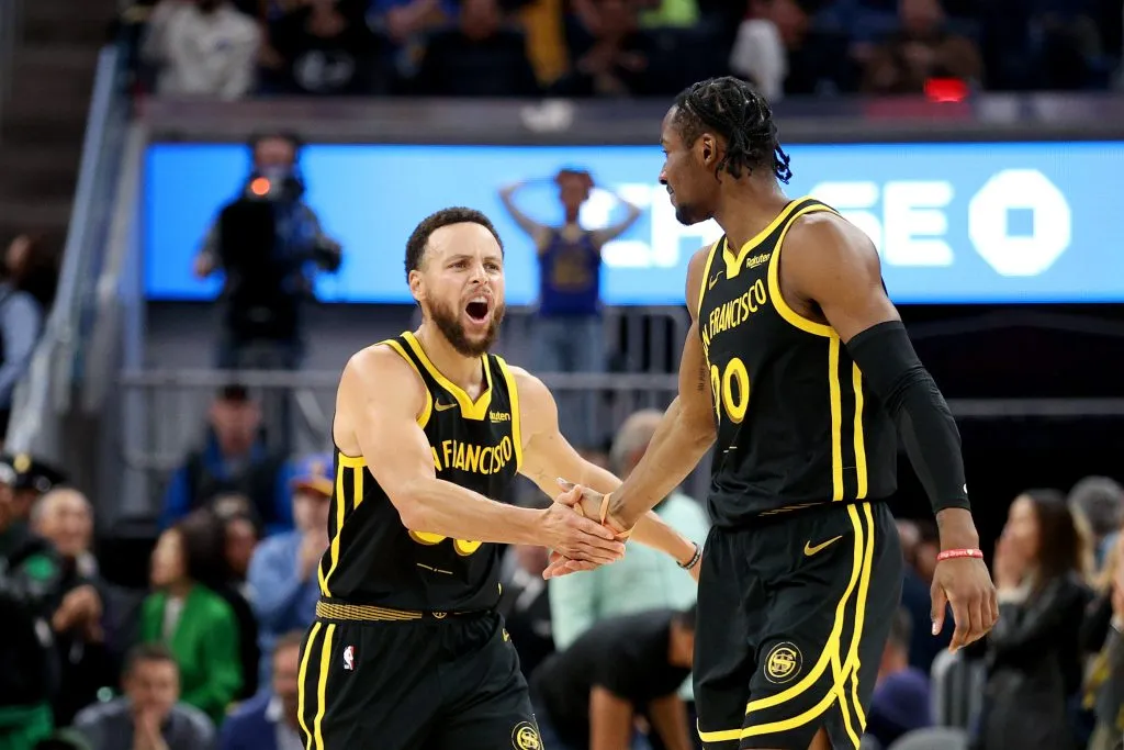 Stephen Curry #30 congratulates Jonathan Kuminga #00 of the Golden State Warriors during their game against the Boston Celtics. Ezra Shaw/Getty Images