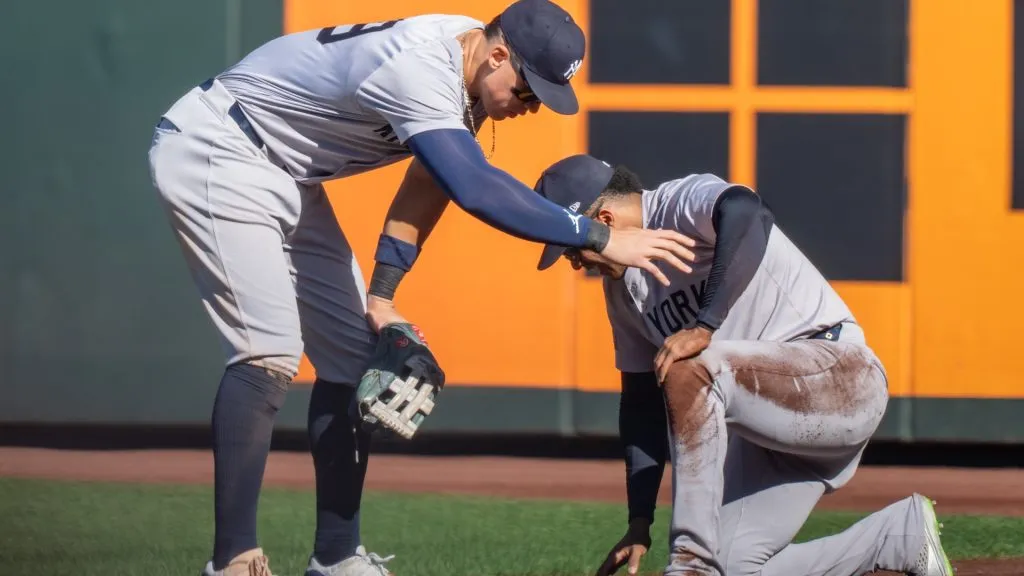 Centerfielder Aaron Judge #99 of the New Yankees checks on right fielder Juan Soto #22 who collided with the wall in the seventh inning at T-Mobile Park on September 19, 2024 in Seattle, Washington. (Photo by Stephen Brashear/Getty Images)