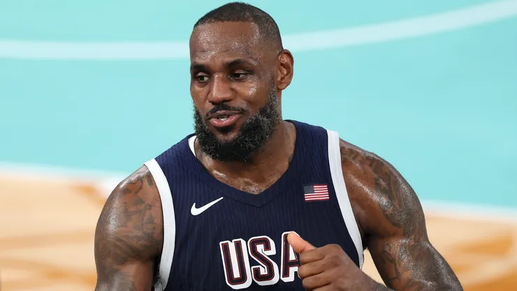 LeBron James #6 of Team United States high fives former NBA player Carmelo Anthony after Team United States's victory against Team France during the Men's Gold Medal game between Team France and Team United States on day fifteen of the Olympic Games Paris 2024.