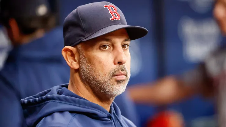 Boston Red Sox manager Alex Cora (13) watches players warm up ahead of a game against the Tampa Bay Rays.