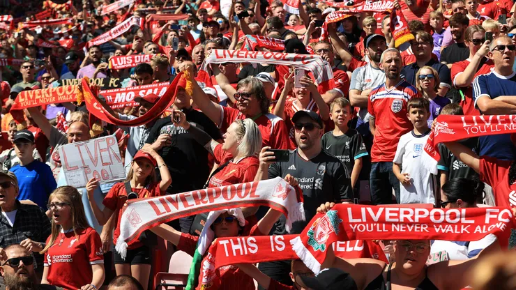 Liverpool fans raise their scarves