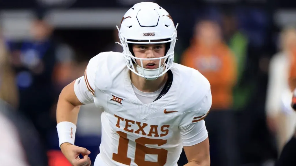 Quarterback Arch Manning #16 of the Texas Longhorns runs behind the line against the Oklahoma State Cowboys in the second half of the Big 12 Championship at AT&T Stadium on December 2, 2023 in Arlington, Texas.