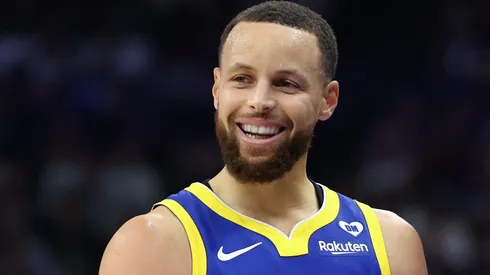 Stephen Curry #30 of the Golden State Warriors jokes with Sacramento Kings head coach Mike Brown in the first quarter during the Play-In Tournament at Golden 1 Center on April 16, 2024 in Sacramento, California.