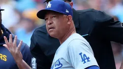 Manager Dave Roberts #30 of the Los Angeles Dodgers speaks with umpires prior to a game against the Milwaukee Brewers at American Family Field.