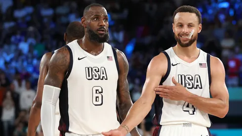 LeBron James #6 of Team United States watches as Stephen Curry #4 of Team United States celebrates towards his bench