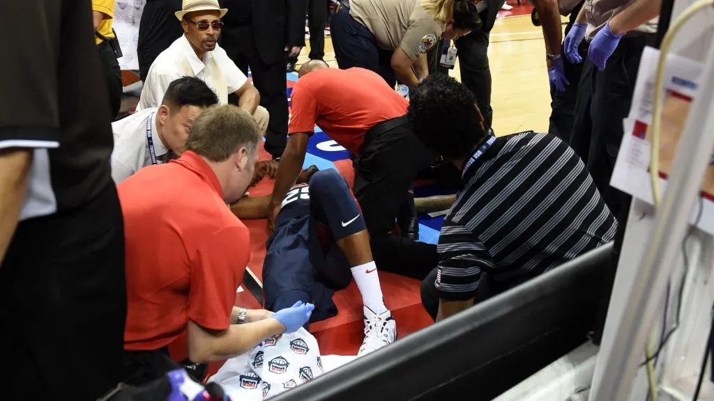 Paul George #29 of the 2014 USA Basketball Men’s National Team is tended to as he lies on the court after badly injuring his leg defending a play during a USA Basketball showcase. Ethan Miller/Getty Images