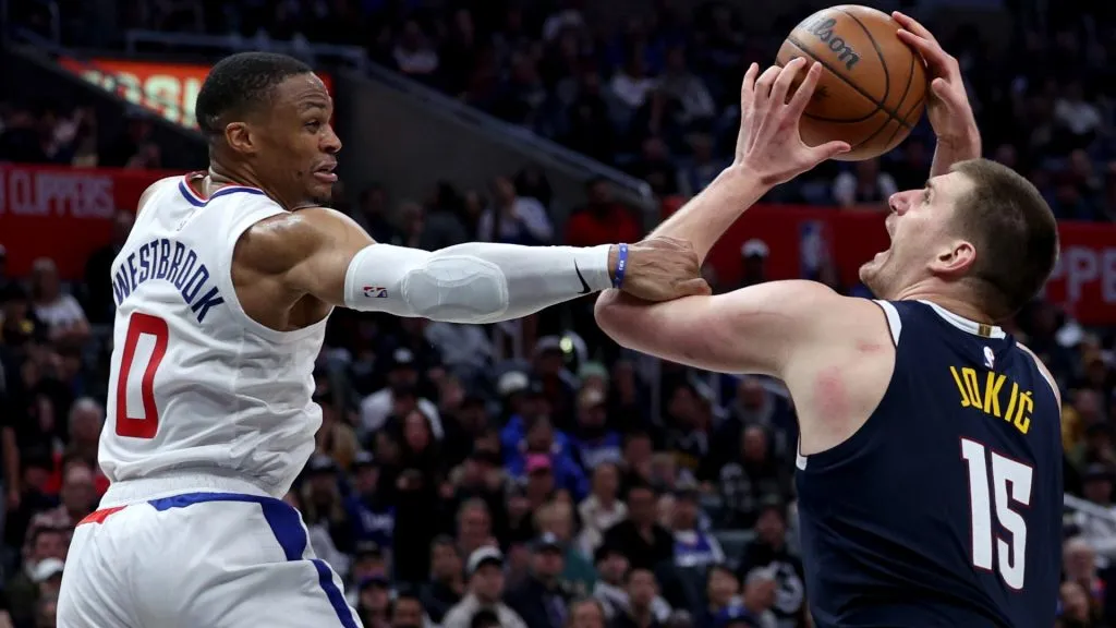 Nikola Jokic #15 of the Denver Nuggets reacts as he is fouled by Russell Westbrook #0 of the LA Clippers during a 102-100 Clippers win at Crypto.com Arena. (Photo by Harry How/Getty Images)