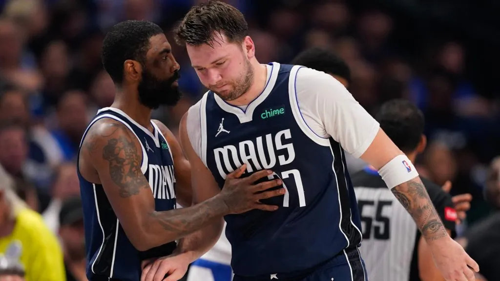 Luka Doncic #77 of the Dallas Mavericks is greeted by Kyrie Irving #11 as he walks off the court after being injured during the first half of game three of the Western Conference First Round Playoffs. Sam Hodde/Getty Images