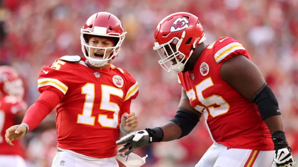 Patrick Mahomes #15 of the Kansas City Chiefs celebrates with Trey Smith #65 after throwing a touchdown pass during the fourth quarter at Arrowhead Stadium on September 12, 2021 in Kansas City, Missouri.