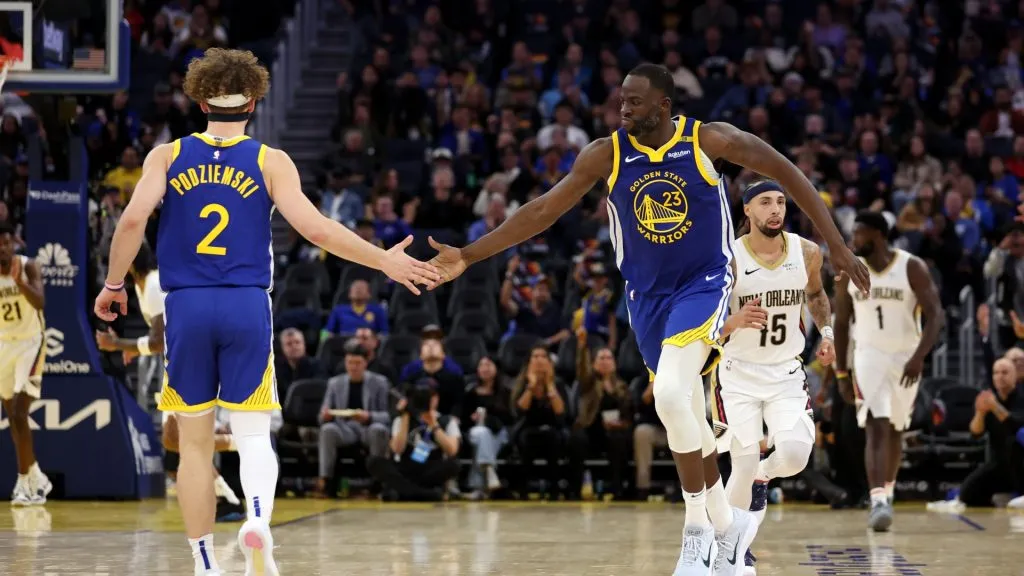Draymond Green #23 high-fives Brandin Podziemski #2 of the Golden State Warriors after he made a basket against the New Orleans Pelicans in the second half at Chase Center on October 30, 2024 in San Francisco, California. (Photo by Ezra Shaw/Getty Images)