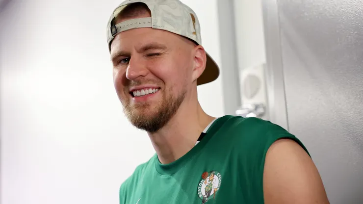 Kristaps Porzingis #8 of the Boston Celtics winks during a press conference after Boston's 106-88 win against the Dallas Mavericks in Game Five of the 2024 NBA Finals at TD Garden on June 17, 2024 in Boston, Massachusetts.