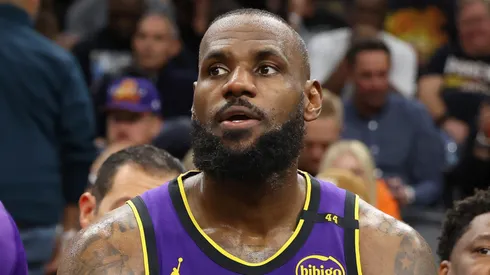 Bronny James #9 and LeBron James #23 of the Los Angeles Lakers sit on the bench during the second half of the NBA game against the Phoenix Suns at Footprint Center on October 28, 2024 in Phoenix, Arizona. The Suns defeated the Lakers 109-105.