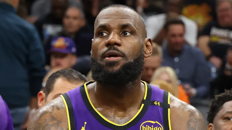 Bronny James #9 and LeBron James #23 of the Los Angeles Lakers sit on the bench during the second half of the NBA game against the Phoenix Suns at Footprint Center on October 28, 2024 in Phoenix, Arizona. The Suns defeated the Lakers 109-105.