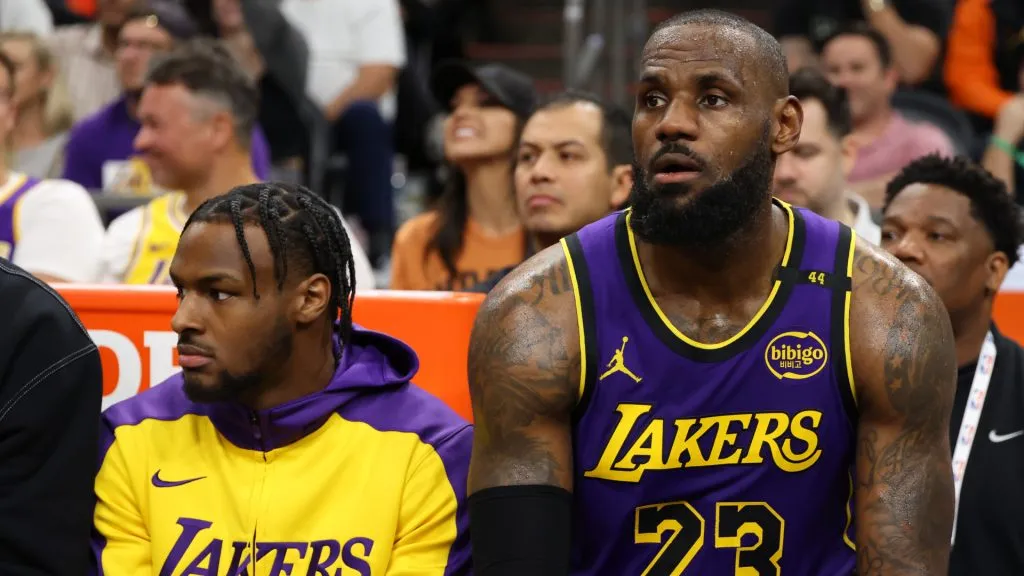 Bronny James #9 and LeBron James #23 of the Los Angeles Lakers look on during the second half against the Phoenix Suns.