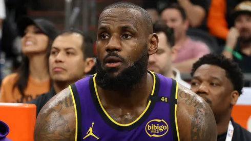 Bronny James #9 and LeBron James #23 of the Los Angeles Lakers look on during the second half against the Phoenix Suns at Footprint Center on October 28, 2024 in Phoenix, Arizona.