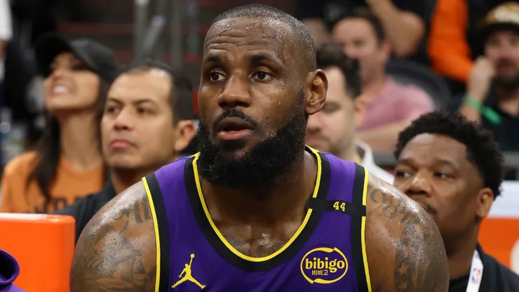 Bronny James #9 and LeBron James #23 of the Los Angeles Lakers look on during the second half against the Phoenix Suns at Footprint Center on October 28, 2024 in Phoenix, Arizona.