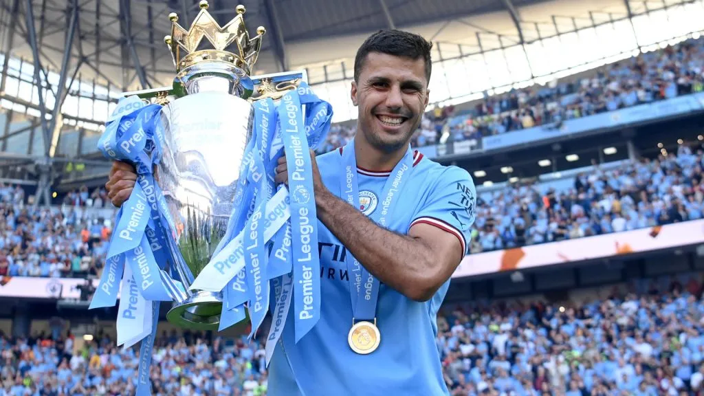 Rodri of Manchester City poses for a photograph with the Premier League Trophy (Michael Regan/Getty Images)