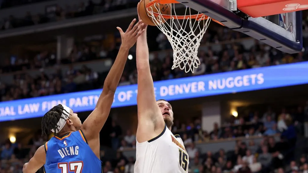 Nikola Jokic #15 of the Denver Nuggets goes to the basket against Ousmane Dieng #13 of the Oklahoma City Thunder in the first quarter at Ball Arena on October 24, 2024 in Denver, Colorado. 