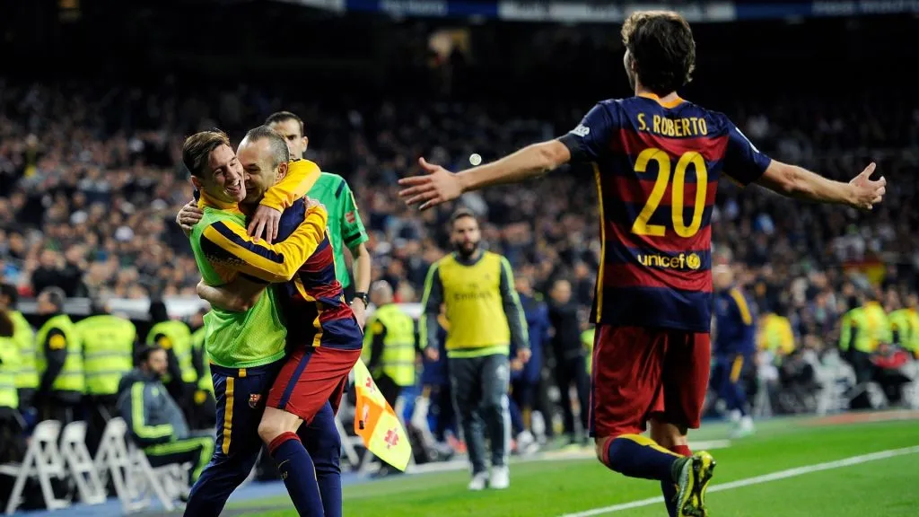 Andres Iniesta of FC Barcelona celebrates with Lionel Messi after scoring his team's 3rd goal during the La Liga match between Real Madrid and Barcelona at Estadio Santiago Bernabeu on November 21, 2015 in Madrid, Spain.