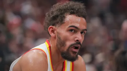 Trae Young 11 of the Atlanta Hawks looks on form the bench during first half of the 2024 Play-In Tournament against the Chicago Bulls at the United Center on April 17, 2024 in Chicago, Illinois.