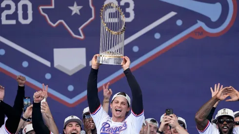 Corey Seager #5 of the Texas Rangers lifts the Commissioner's Trophy during the World Series Championship celebration at Globe Life Field on November 03, 2023 in Arlington, Texas.