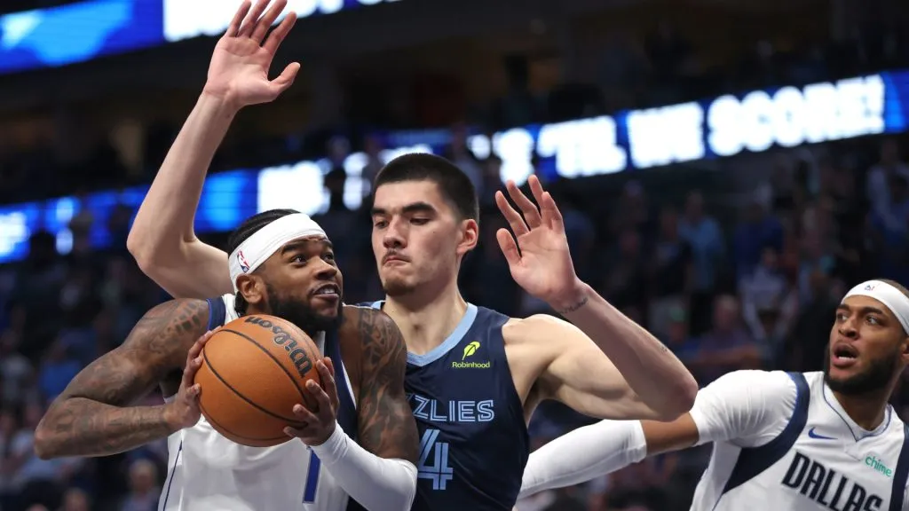 HJaden Hardy #1 of the Dallas Mavericks drives to the basket against Zach Edey #14 of the Memphis Grizzlies in the first half of a preseason game at American Airlines Center on October 7, 2024 in Dallas, Texas. (Photo by Ron Jenkins/Getty Images)