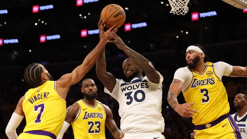 Julius Randle #30 of the Minnesota Timberwolves reacts as he grabs a rebound between Gabe Vincent #7, LeBron James #23 and Anthony Davis #3 of the Los Angeles Lakers during a 110-103 loss to the Los Angeles Lakers in the season home opener at Crypto.com Arena on October 22, 2024 in Los Angeles, California.