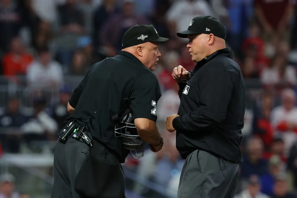 Umpires Mark Carlson and Brian O’Nora speak during the seventh inning Game One of the Division Series between the Atlanta Braves and the Philadelphia Phillies at Truist Park on October 07, 2023 in Atlanta, Georgia. (Photo by Kevin C. Cox/Getty Images)