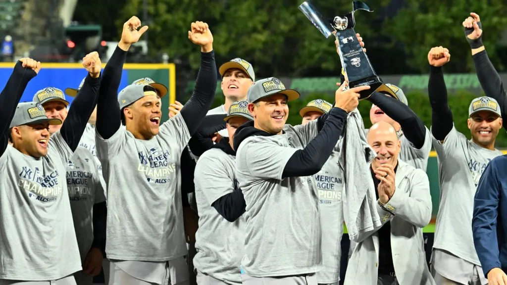 Manager Aaron Boone of the New York Yankees celebrates with the trophy after beating the Cleveland Guardians 5-2 in 10 innings in Game Five of the American League Championship Series at Progressive Field on October 19, 2024 in Cleveland, Ohio. (Photo by Jason Miller/Getty Images)