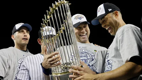 (L-R) Andy Pettitte #46, Jorge Posada #20, Derek Jeter #2 and Mariano Rivera #42 of the New York Yankees celebrate with the trophy after their 7-3 win against the Philadelphia Phillies in Game Six of the 2009 MLB World Series at Yankee Stadium on November 4, 2009 in the Bronx borough of New York City.