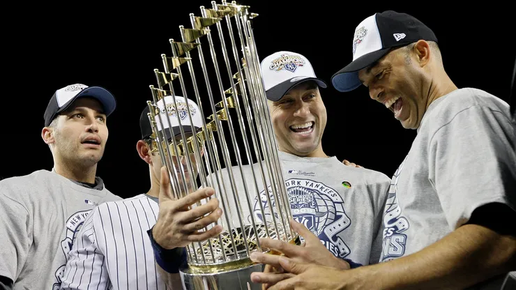 (L-R) Andy Pettitte #46, Jorge Posada #20, Derek Jeter #2 and Mariano Rivera #42 of the New York Yankees celebrate with the trophy after their 7-3 win against the Philadelphia Phillies in Game Six of the 2009 MLB World Series at Yankee Stadium on November 4, 2009 in the Bronx borough of New York City.