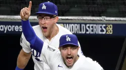 A.J. Pollock #11 and Will Smith #16 of the Los Angeles Dodgers celebrate after defeating the Tampa Bay Rays 3-1 in Game Six to win the 2020 MLB World Series at Globe Life Field on October 27, 2020 in Arlington, Texas.