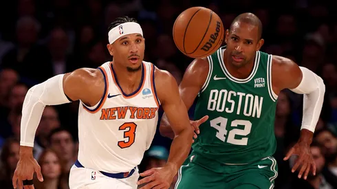 Josh Hart #3 of the New York Knicks and Al Horford #42 of the Boston Celtics chase after the ball at Madison Square Garden on October 25, 2023 in New York City.
