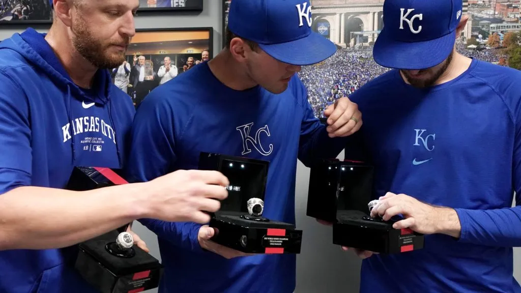 Will Smith #31, Cole Ragans #55 and Chris Stratton #35 of the Kansas City Royals look at the 2023 World Series Championship rings they won with the Texas Rangers during a presentation prior to the game against the Texas Rangers at Kauffman Stadium on May 03, 2024 in Kansas City, Missouri. (Photo by Ed Zurga/Getty Images)