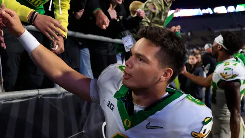 Dillon Gabriel #8 of the Oregon Ducks interacts with fans after the game against the Purdue Boilermakers at Ross-Ade Stadium on October 18, 2024 in West Lafayette, Indiana.