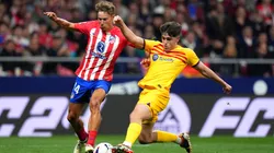 Marcos Llorente of Atletico Madrid is challenged by Pau Cubarsi of FC Barcelona during the LaLiga EA Sports match between Atletico Madrid and FC Barcelona at Civitas Metropolitano Stadium on March 17, 2024 in Madrid, Spain. (Photo by Angel Martinez/Getty Images)