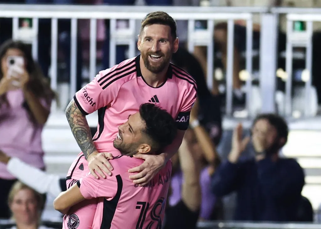 Lionel Messi #10 of Inter Miami celebrates with Jordi Alba #18 after scoring his second goal during the second half against the New England Revolution. Carmen Mandato/Getty Images