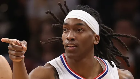 Terance Mann #14 of the LA Clippers reacts to a three-point shot over Devin Booker #1 of the Phoenix Suns during the first half of the NBA game at Footprint Center on April 09, 2024 in Phoenix, Arizona.