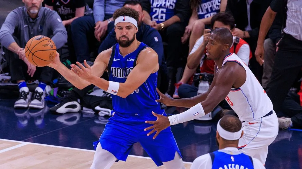 Kris Dunn 8 of the Los Angeles Clippers defends against Klay Thompson 31 of the Dallas Mavericks during their preseason game on Monday October 14, 2024 at Intuit Dome Arena in Inglewood, California. 
