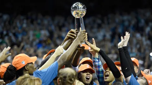 Minnesota Lynx raise the Championship trophy after defeating the Los Angeles Sparks in Game Five of the WNBA Finals on October 4, 2017