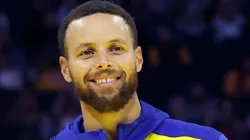 Jonnie West, the Warriors senior director of pro player personnel and son of Jerry West, presents Stephen Curry #30 of the Golden State Warriors the Jerry West Trophy as the Kia NBA Clutch Player of the Year last season before their preseason game against the Los Angeles Lakers at Chase Center on October 18, 2024 in San Francisco, California.
