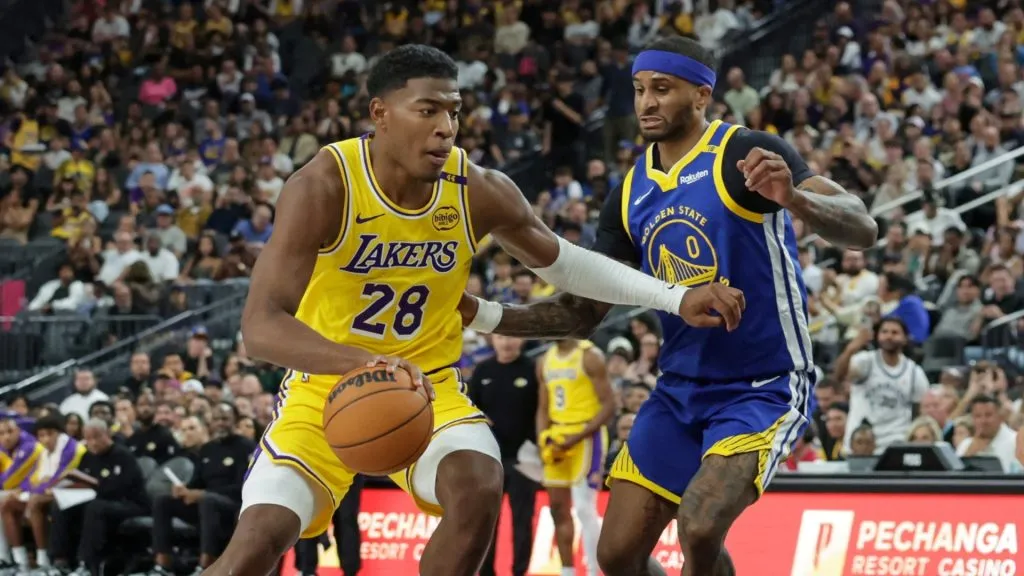 Rui Hachimura #28 of the Los Angeles Lakers drives against Gary Payton II #0 of the Golden State Warriors in the fourth quarter of their preseason game at T-Mobile Arena at T-Mobile Arena on October 15, 2024 in Las Vegas, Nevada. The Warriors defeated the Lakers 111-97. 