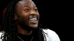 Alvin Kamara (41) of the New Orleans Saints smiles showing his diamond grill before a game against the Atlanta Falcons at Mercedes-Benz Stadium on September 29, 2024 in Atlanta, Georgia.