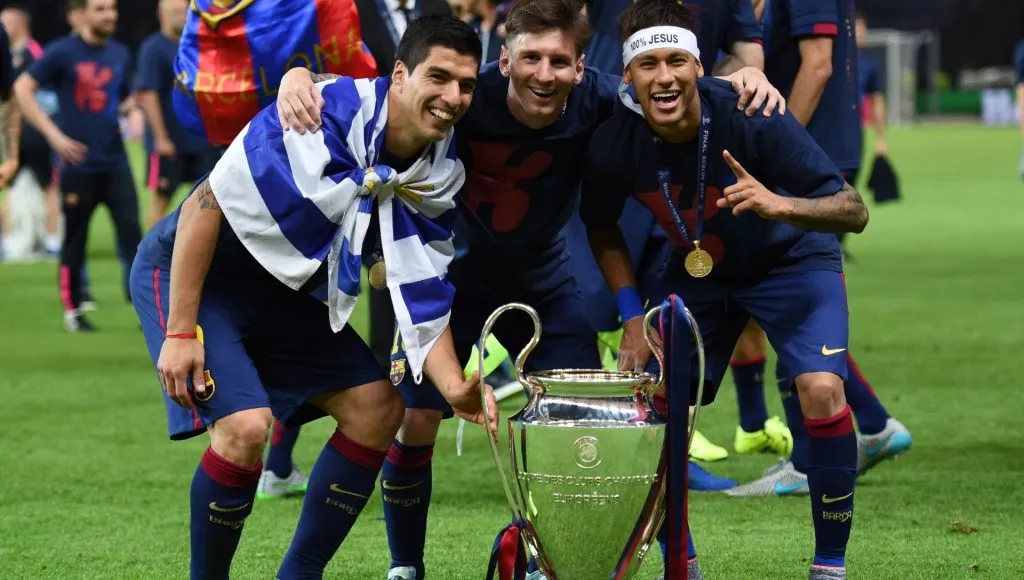 Luis Suarez, Lionel Messi and Neymar of Barcelona celebrate with the trophy after the UEFA Champions League Final between Juventus and FC Barcelona at Olympiastadion on June 6, 2015 in Berlin, Germany.