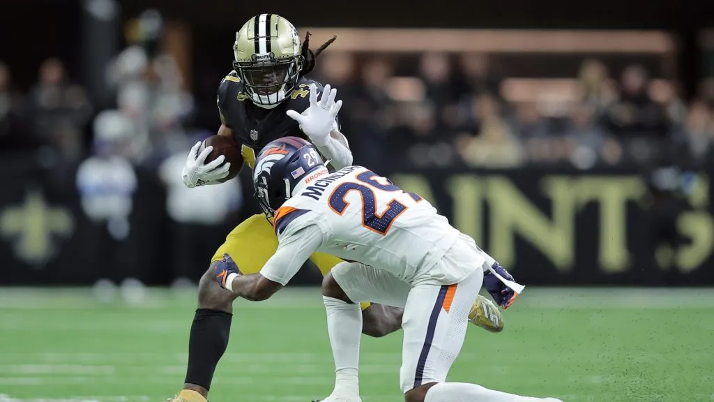 Alvin Kamara #41 of the New Orleans Saints is brought down by Ja’Quan McMillian #29 of the Denver Broncos during the second quarter at Caesars Superdome on October 17, 2024 in New Orleans, Louisiana
