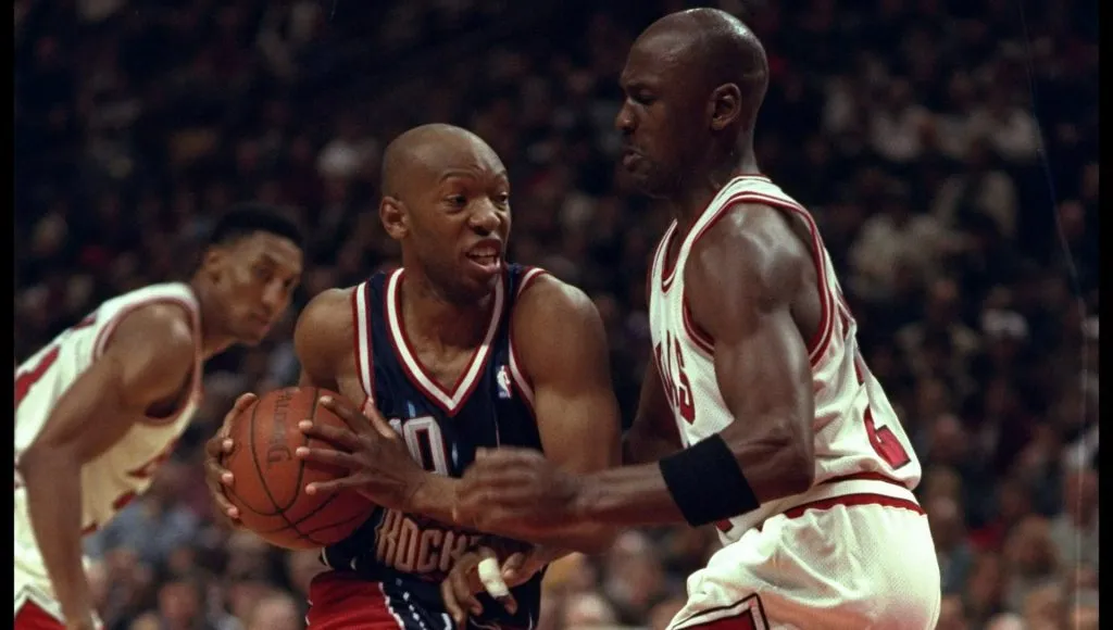 Sam Cassell of the Houston Rockets goes against guard Michael Jordan of the Chicago Bulls during a game played at the United Center in Chicago, Illinois. The Bulls won the game, 100-86.