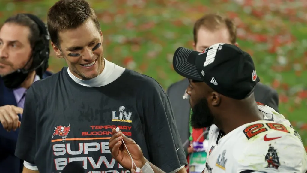 Tom Brady #12 of the Tampa Bay Buccaneers is interviewed with Leonard Fournette #28 after winning Super Bowl LV at Raymond James Stadium on February 07, 2021 in Tampa, Florida. The Buccaneers defeated the Chiefs 31-9.