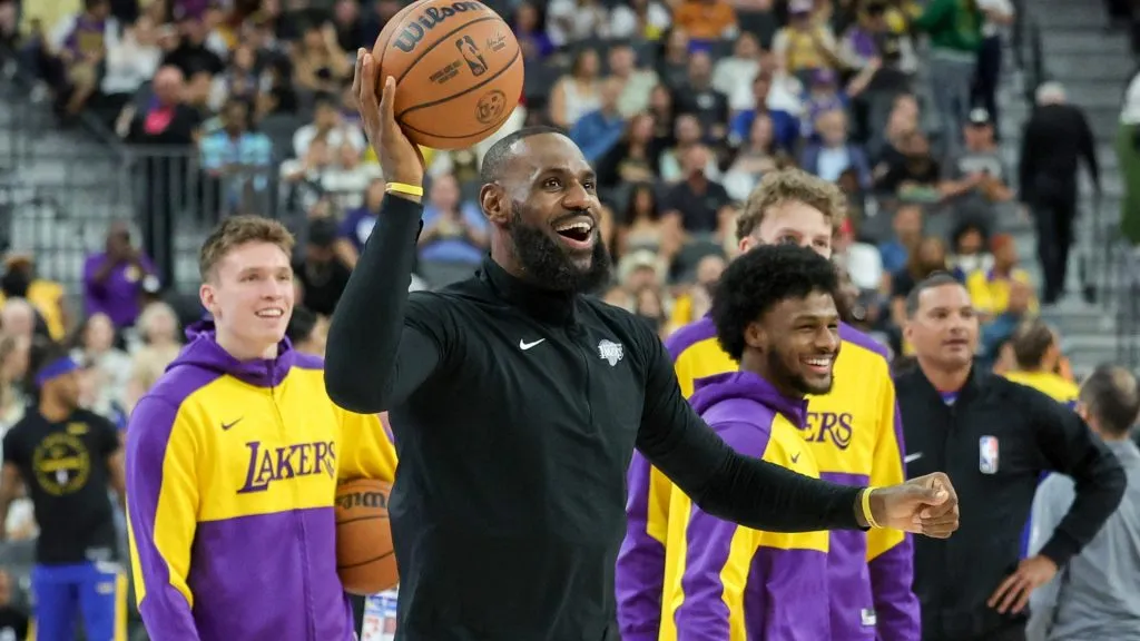 (L-R) Dalton Knecht #4, LeBron James #23 and Bronny James #9 of the Los Angeles Lakers warm up before a preseason game against the Golden State Warriors at T-Mobile Arena at T-Mobile Arena on October 15, 2024 in Las Vegas, Nevada. The Warriors defeated the Lakers 111-97. (Photo by Ethan Miller/Getty Images)