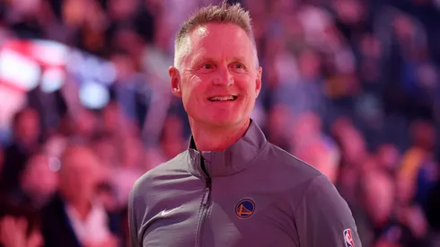 Golden State Warriors head coach Steve Kerr stands for the national anthem before their preseason game against the Sacramento Kings