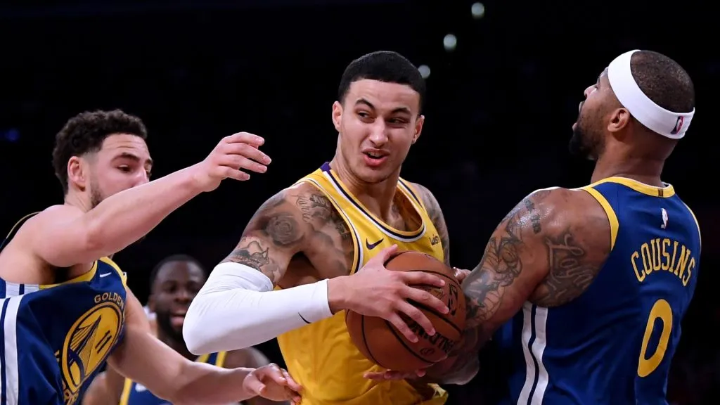 Kyle Kuzma #0 of the Los Angeles Lakers reacts to a DeMarcus Cousins #0 of the Golden State Warriors foul as he drives past Klay Thompson #11 during a 130-111 Warriors win at Staples Center on January 21, 2019 in Los Angeles, California.